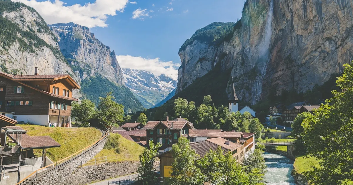 An Alpine valley with a village and mountains