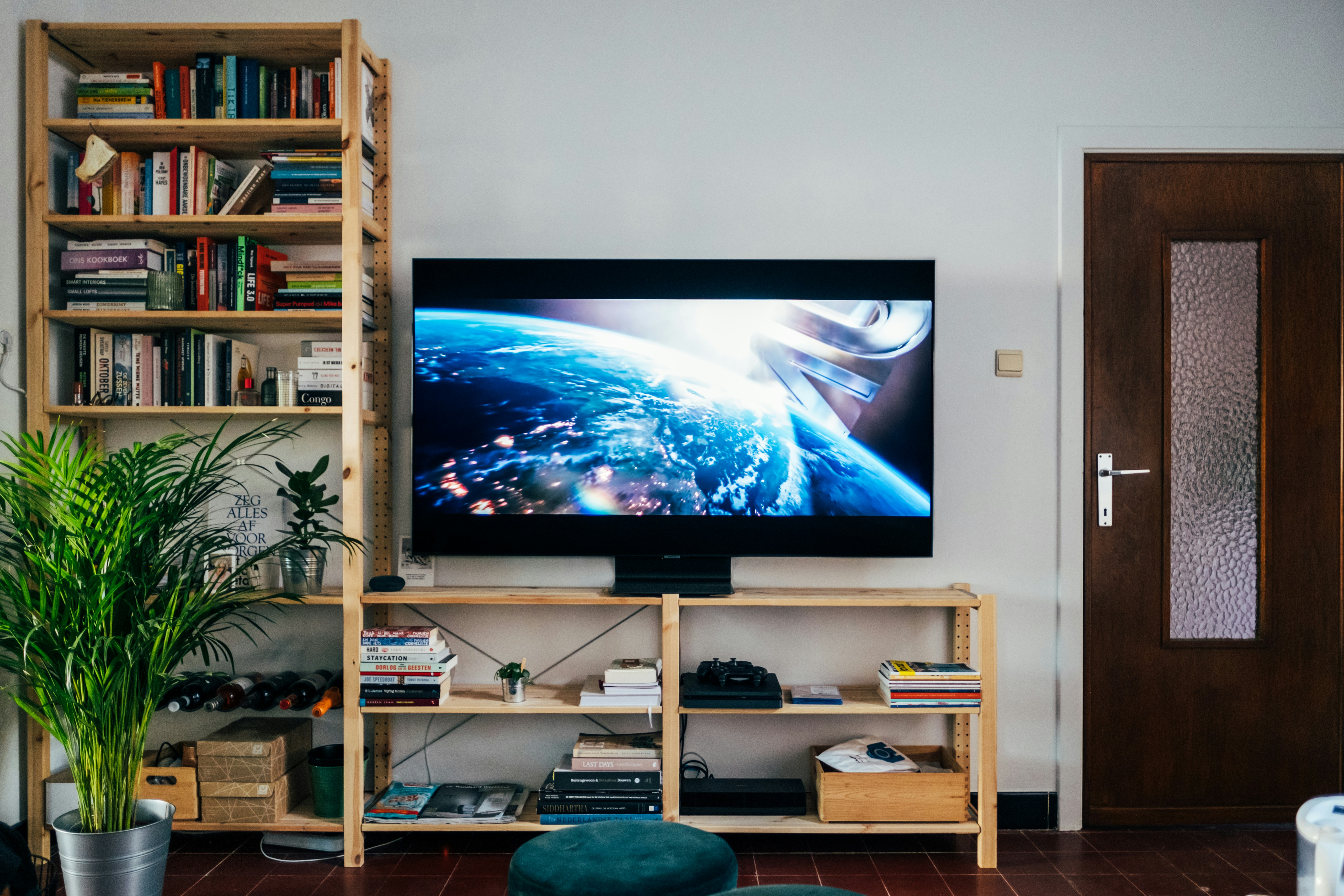 A modern living room with a flat screen TV showing a streaming interface