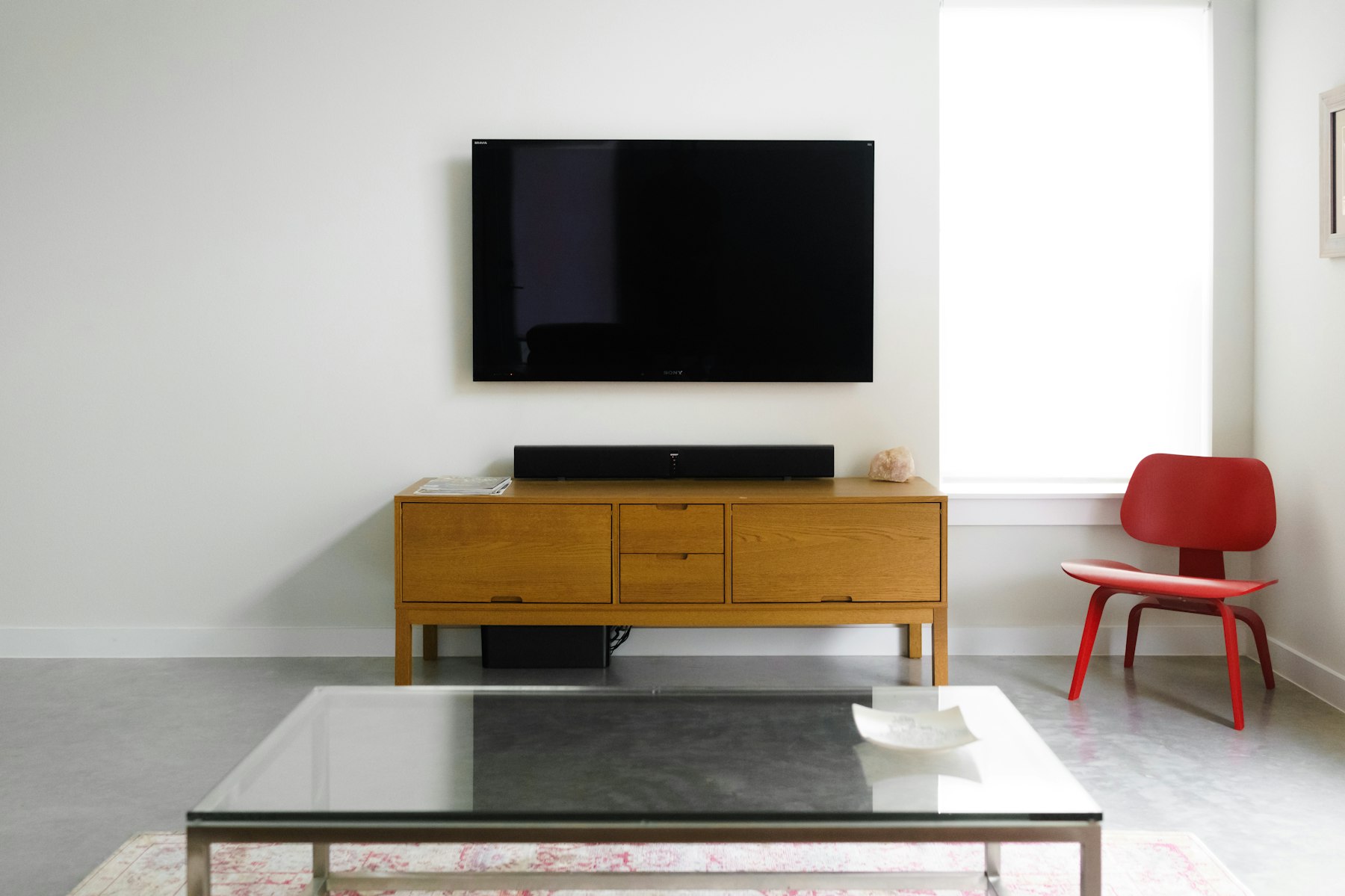 A modern living room with a television and streaming interface on screen
