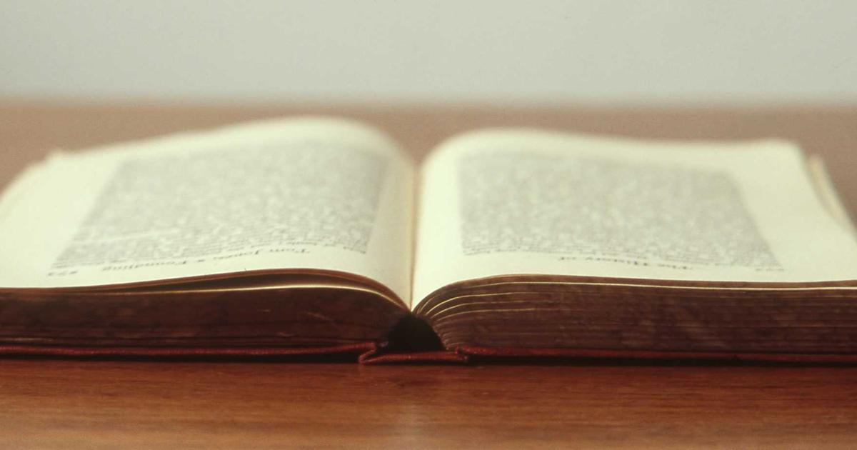 Tablet showing a Greek-language IPTV channel guide with Cypriot landscape in the background