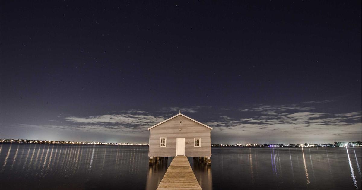 Smart television showing Greek IPTV channel guide with Aegean Sea view through window