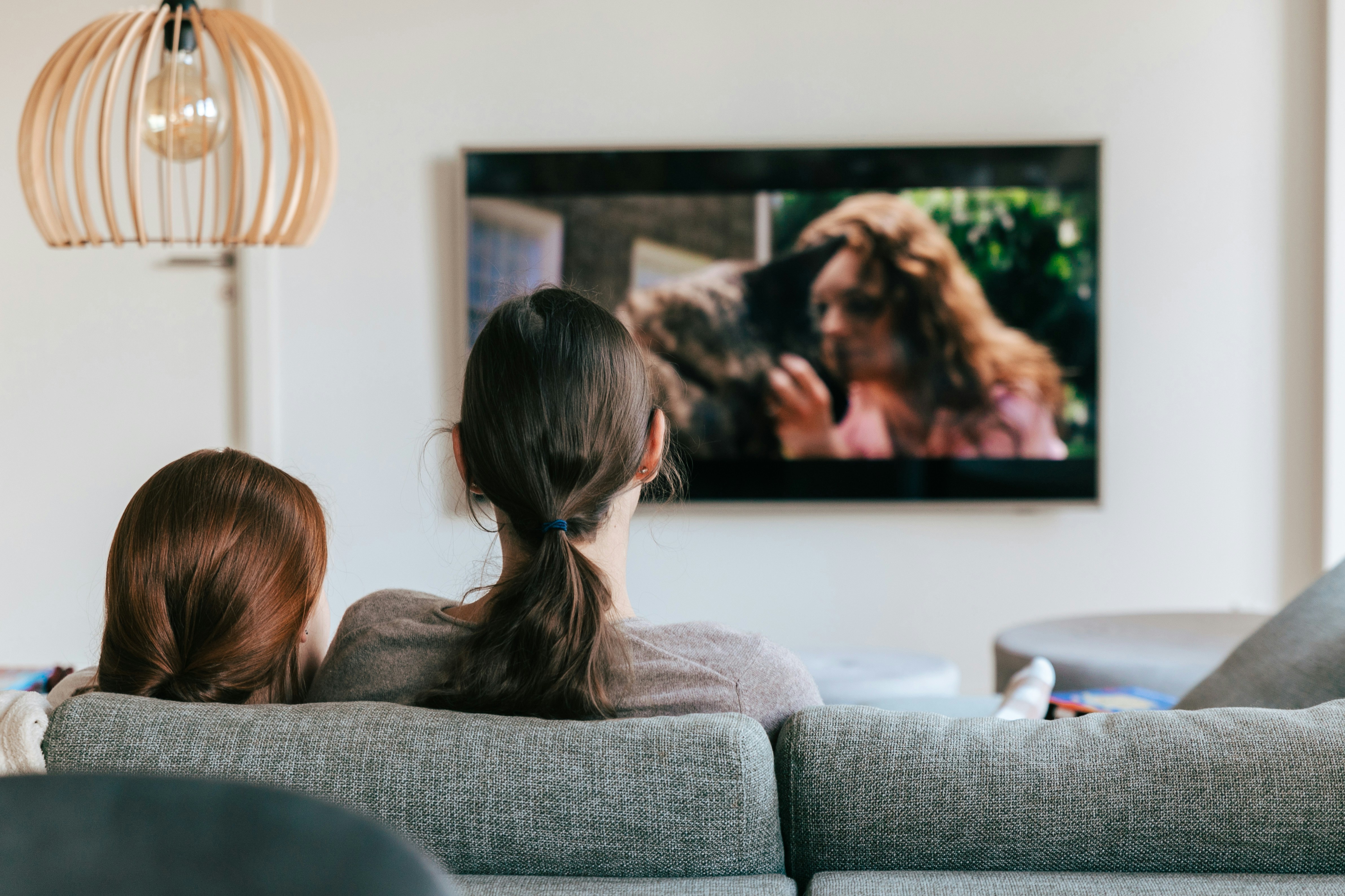 A modern smart TV in a living room showing a streaming interface